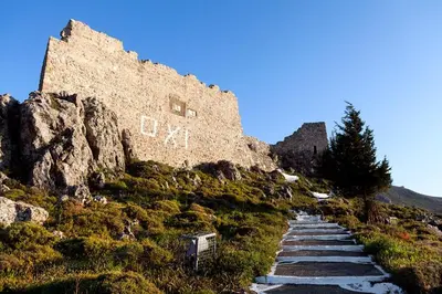 a path in front of a castle on a hill at Antonia's Apartments in Archangelos