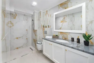 a white bathroom with a sink and a shower at Antonia's Apartments in Archangelos
