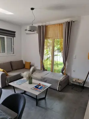 a living room with a couch and a table at Rhodes Comfort Luxury Apartment in Rhodes Town