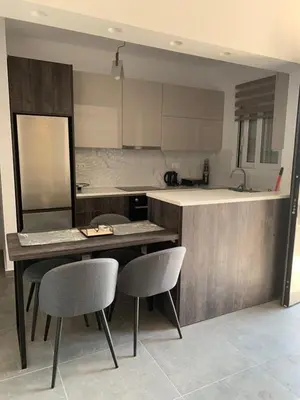 a kitchen with a table and two chairs in it at Rhodes Comfort Luxury Apartment in Rhodes Town