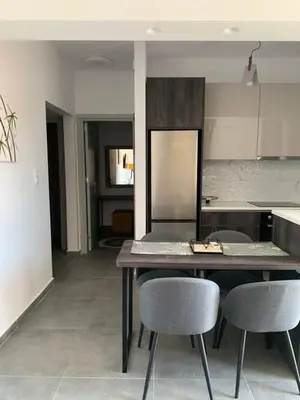a kitchen with a table and chairs in a room at Rhodes Comfort Luxury Apartment in Rhodes Town