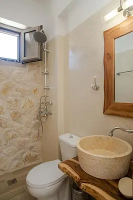 a bathroom with a sink and a toilet at AENAON in Archangelos