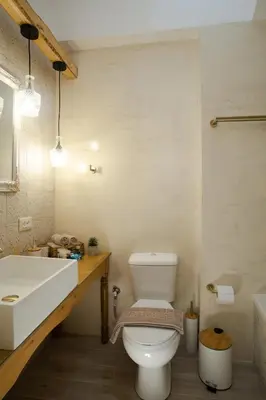 a bathroom with a white toilet and a sink at AENAON in Archangelos