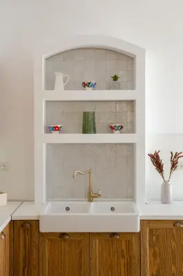 a white kitchen with a sink and a shelf at AENAON in Archangelos