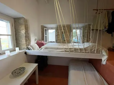 a bedroom with a swinging bed in a room at villa Elpiniki Tilos in Megálon Choríon
