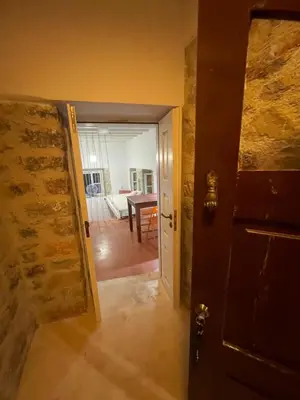 an open door to a room with a table in it at villa Elpiniki Tilos in Megálon Choríon
