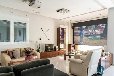 a living room with a tv and a large screen at GGA Albatross Villa in Afantou