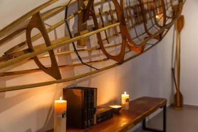a wooden table with two candles and a staircase at Thalassa Luxury Villa in Ialyssos
