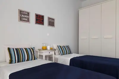 two beds sitting next to each other in a room at Thalassa Luxury Villa in Ialyssos