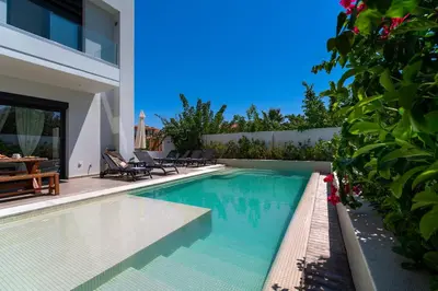 a swimming pool in the backyard of a house at Thalassa Luxury Villa in Ialyssos
