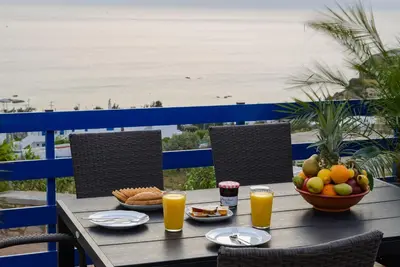 a table with food and drinks and a bowl of fruit at Villa Leonardo in Archangelos