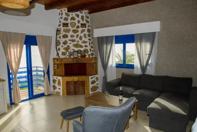 a living room with a couch and a table at Villa Leonardo in Archangelos