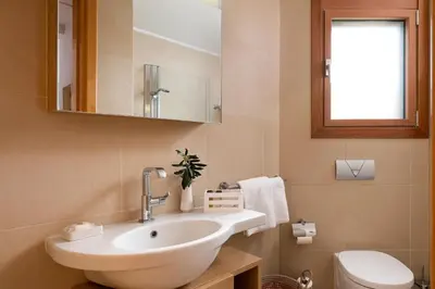 a bathroom with a sink and a toilet at Love White Villa in Ialyssos
