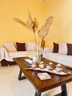 a living room with a table and a couch at Elia Old Mansion in Malona Village