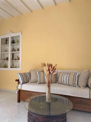 a living room with a couch and a glass table at Elia Old Mansion in Malona Village