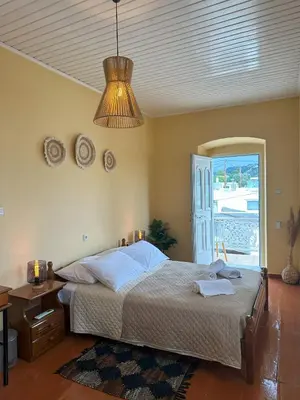 a bedroom with a bed and a chandelier at Elia Old Mansion in Malona Village