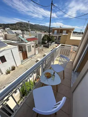 a balcony with two chairs and a table on a balcony at Elia Old Mansion in Malona Village