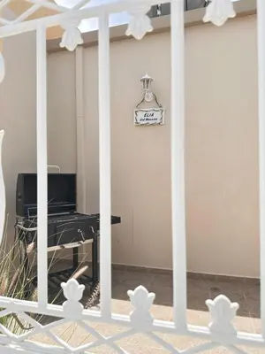 a room with a table and a clock on the wall at Elia Old Mansion in Malona Village