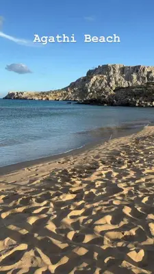 a beach with footprints in the sand and the ocean at Elia Old Mansion in Malona Village