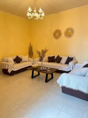 a living room with two couches and a table at Elia Old Mansion in Malona Village