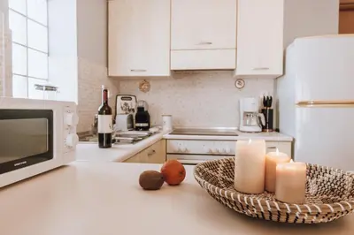 a kitchen with a counter with candles and a microwave at Iliotti Apartments in Rhodes Town