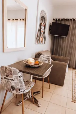 a living room with a table and a couch at Iliotti Apartments in Rhodes Town