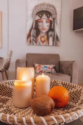 a table with candles and an orange on it at Iliotti Apartments in Rhodes Town