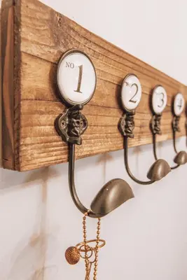 a wooden wall clock with four clocks on it at Iliotti Apartments in Rhodes Town