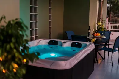 a hot tub in a living room with a christmas tree at Greek Style Apartment with Jaquzzi & Barbeque in Triánta