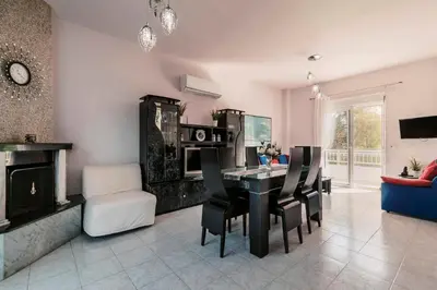 a living room with a black table and chairs at Greek Style Apartment with Jaquzzi & Barbeque in Triánta