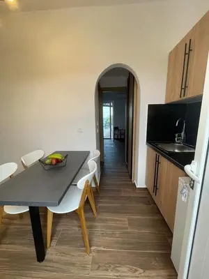 a kitchen and dining room with a table and chairs at Gennadi Beach Apartments in Gennadi