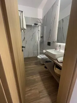 a bathroom with a sink and a toilet at Gennadi Beach Apartments in Gennadi