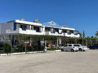 a white car parked in front of a building at Gennadi Beach Apartments in Gennadi