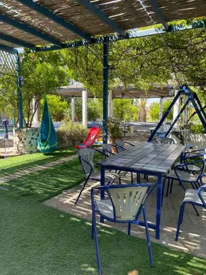 a picnic table and chairs in a park at Gennadi Beach Apartments in Gennadi