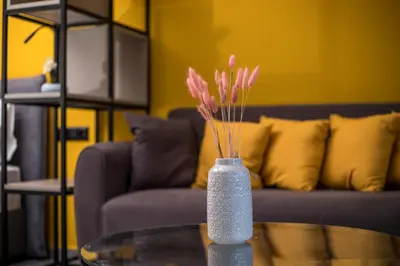 a vase with pink flowers sitting on a glass table at GM Apartments-Rhodes Luxury Living in Kalithies