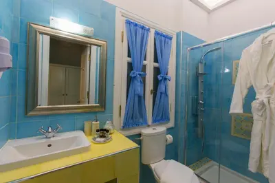 a bathroom with a toilet and a sink and a shower at Efchi 1904 in Rhodes Town