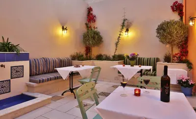 a restaurant with two tables and a couch at Efchi 1904 in Rhodes Town
