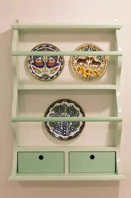 a shelf filled with plates and bowls at Efchi 1904 in Rhodes Town