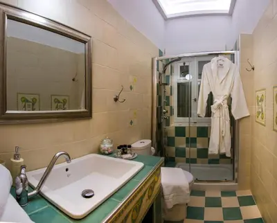 a bathroom with a sink and a shower at Efchi 1904 in Rhodes Town