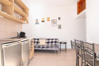 a kitchen with a table and chairs in a room at Arte Lindos Suites in Líndos