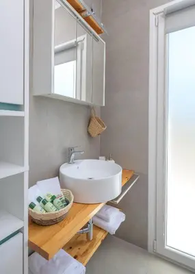 a bathroom with a sink and a mirror at Niva Kamiros Apartments in Kamiros