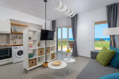 a living room with a couch and a tv at Niva Kamiros Apartments in Kamiros