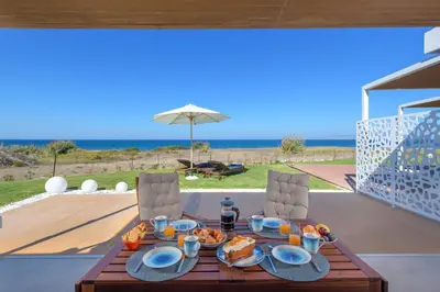 a wooden table with food on top of a patio at Niva Kamiros Apartments in Kamiros