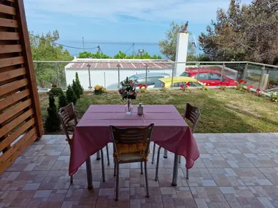 a table with a purple table cloth on a patio at SOLYMAR PRIVE in Archangelos