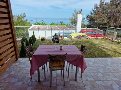 a table with a purple table cloth on a patio at SOLYMAR PRIVE in Archangelos