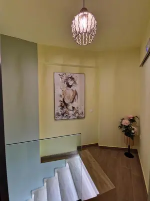 a glass staircase in a room with a painting at SOLYMAR PRIVE in Archangelos
