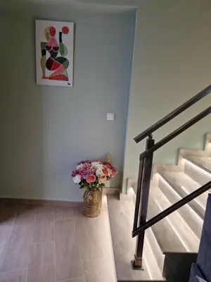 a staircase with a vase of flowers in a room at SOLYMAR PRIVE in Archangelos