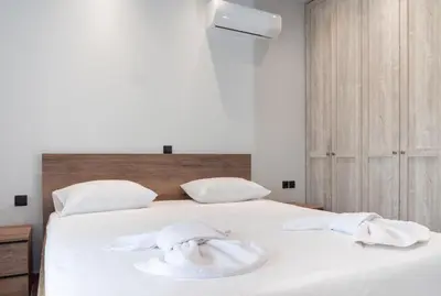 a bedroom with a bed with white towels on it at Apartment Lazarous 3 in Apolakkiá