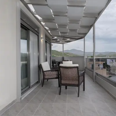 a balcony with chairs and a table with a view at Apartment Lazarous 3 in Apolakkiá