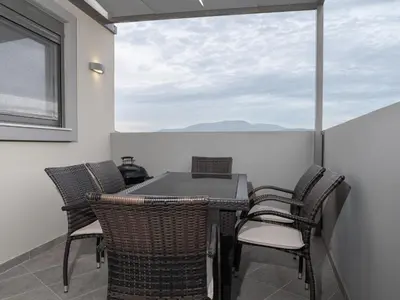 a balcony with a table and chairs and a window at Apartment Lazarous 3 in Apolakkiá